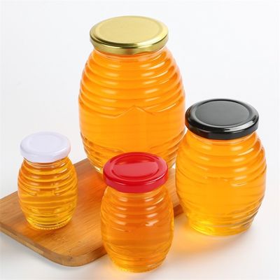 Η μορφή μελισσών βάζα λίγου γυαλιού, φαντάζεται περασμένος κλωστή γύρω από το βάζο γυαλιού με το καπάκι προμηθευτής